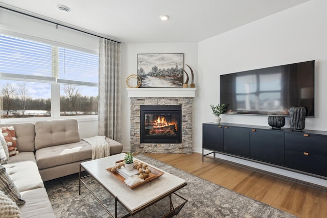 15188 Palm St NW, Andover, MN 55304 - living room with wood finished floors, a stone fireplace, and recessed lighting