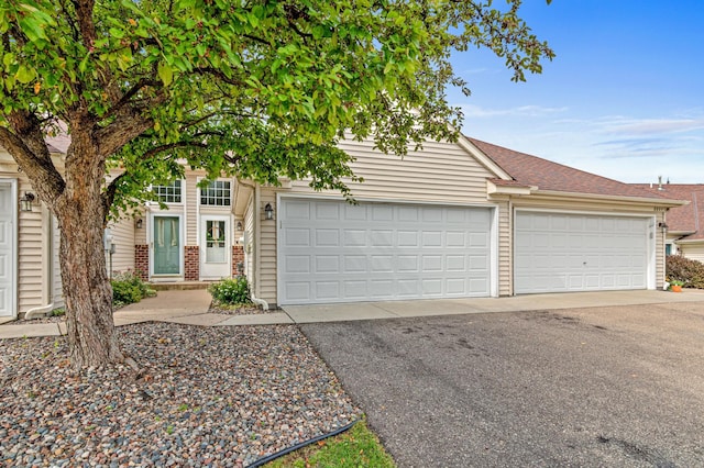 8811 Coffman Path, Inver Grove Heights, MN 55076 - obstructed view of property featuring brick siding, a garage, driveway, and a shingled roof