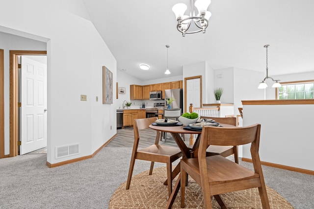 8811 Coffman Path, Inver Grove Heights, MN 55076 - dining area featuring a chandelier, light carpet, and vaulted ceiling