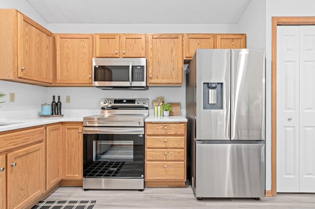 8811 Coffman Path, Inver Grove Heights, MN 55076 - kitchen with appliances with stainless steel finishes, light countertops, and light wood-style flooring