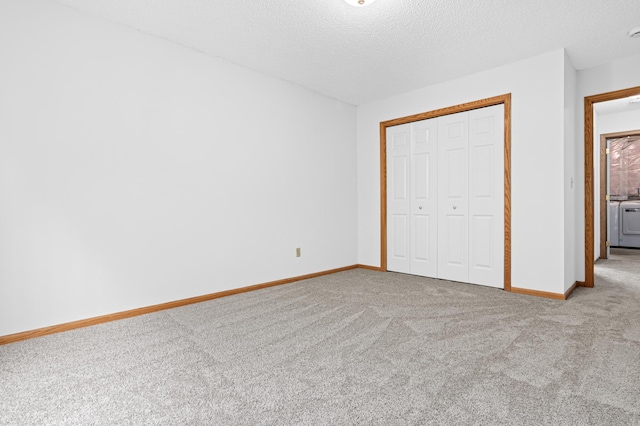 8811 Coffman Path, Inver Grove Heights, MN 55076 - unfurnished bedroom with carpet, a closet, a textured ceiling, and independent washer and dryer