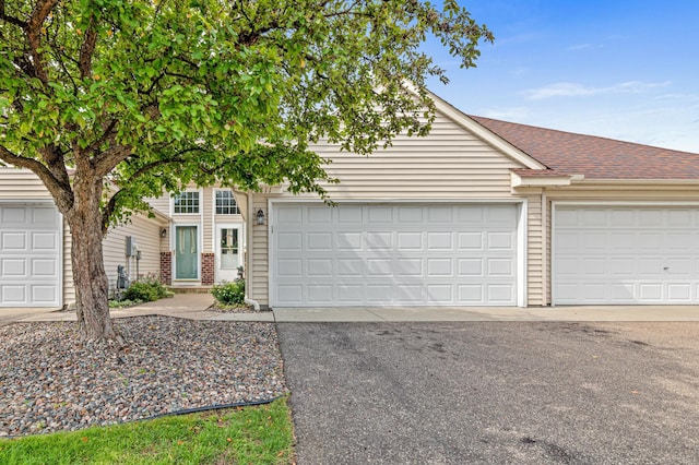 8811 Coffman Path, Inver Grove Heights, MN 55076 - obstructed view of property with a shingled roof and a garage