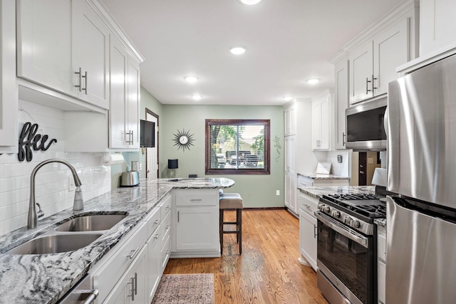 10315 Boundary Creek Ter, Maple Grove, MN 55369 - kitchen featuring appliances with stainless steel finishes, white cabinetry, light wood-type flooring, recessed lighting, and decorative backsplash