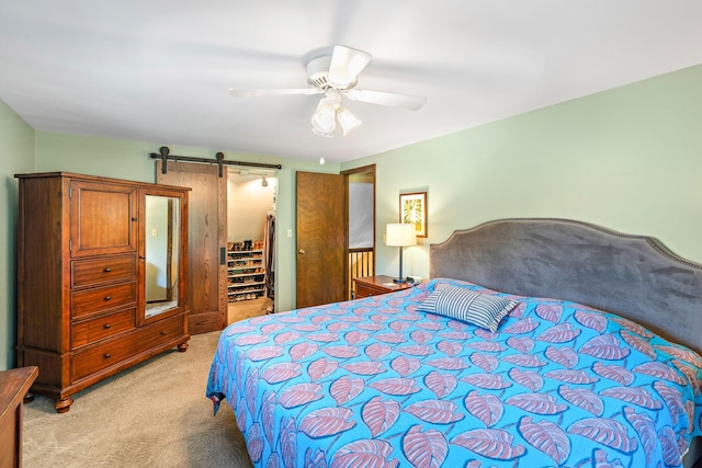 10315 Boundary Creek Ter, Maple Grove, MN 55369 - bedroom with light colored carpet, a spacious closet, a ceiling fan, and a barn door