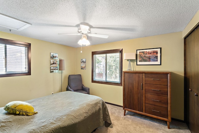10315 Boundary Creek Ter, Maple Grove, MN 55369 - bedroom with light carpet, attic access, ceiling fan, a closet, and a textured ceiling