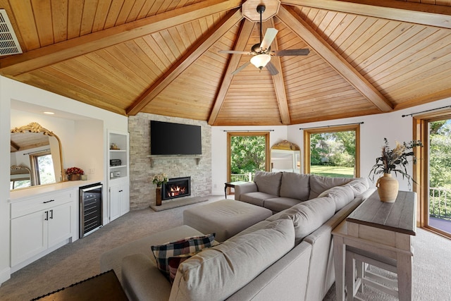 8045 County Road 116, Corcoran, MN 55340 - living area with carpet, wooden ceiling, beverage cooler, a stone fireplace, and a ceiling fan