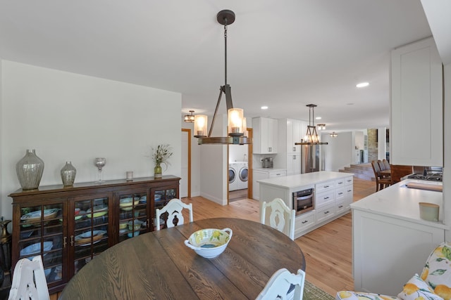8045 County Road 116, Corcoran, MN 55340 - dining room featuring light wood finished floors, a chandelier, recessed lighting, and separate washer and dryer