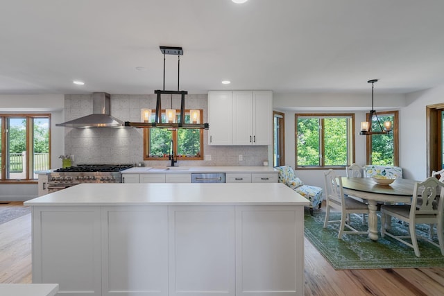 8045 County Road 116, Corcoran, MN 55340 - kitchen with a chandelier, healthy amount of natural light, light wood-style floors, white cabinets, and recessed lighting