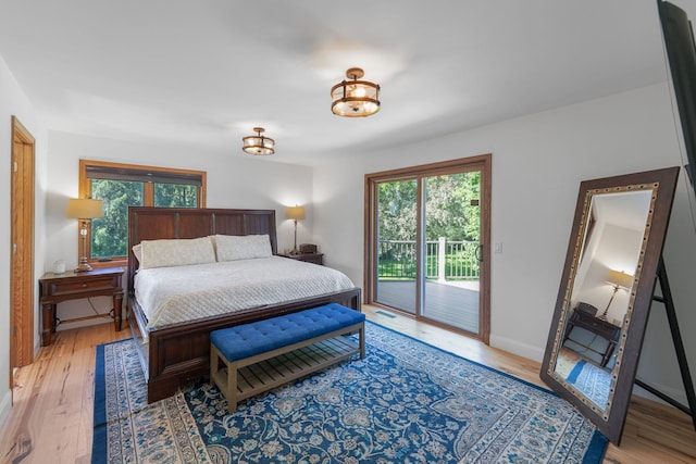 8045 County Road 116, Corcoran, MN 55340 - bedroom with access to outside, multiple windows, and light wood-style flooring