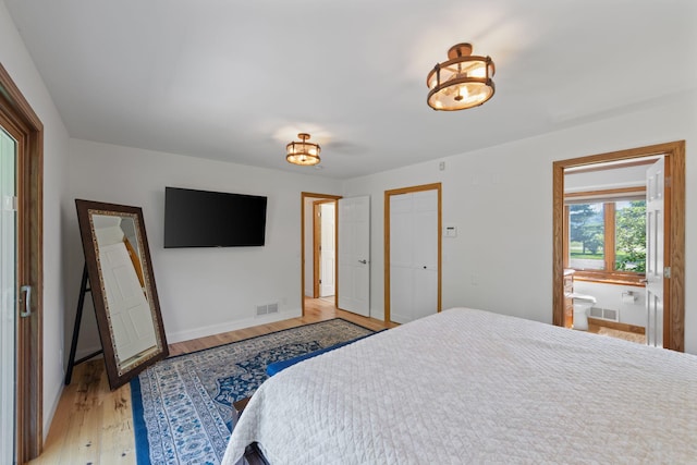 8045 County Road 116, Corcoran, MN 55340 - bedroom featuring light wood-style floors and connected bathroom