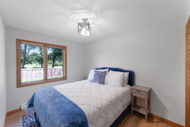 8045 County Road 116, Corcoran, MN 55340 - bedroom featuring wood finished floors and a baseboard radiator