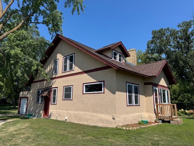 31845 615th Ave, Compton Twp, MN 56482 - view of side of home with a lawn, stucco siding, a chimney, and a garage