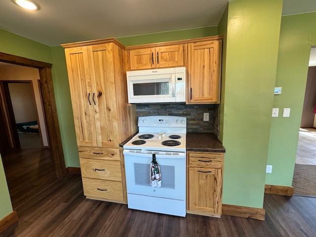31845 615th Ave, Compton Twp, MN 56482 - kitchen with white appliances, dark wood-style floors, tasteful backsplash, and dark countertops