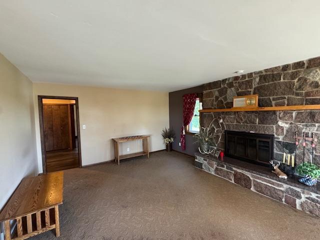 31845 615th Ave, Compton Twp, MN 56482 - unfurnished living room with carpet and a stone fireplace