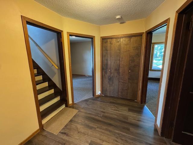 31845 615th Ave, Compton Twp, MN 56482 - corridor featuring a textured ceiling, stairs, and wood finished floors