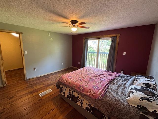 31845 615th Ave, Compton Twp, MN 56482 - bedroom with access to exterior, wood-type flooring, a textured ceiling, and ceiling fan