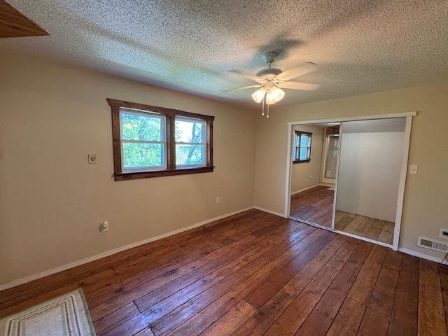 31845 615th Ave, Compton Twp, MN 56482 - unfurnished bedroom with hardwood / wood-style flooring, a closet, a textured ceiling, and ceiling fan