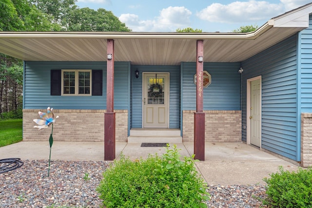 24864 Kettle River Blvd, Wyoming, MN 55025 - entrance to property featuring a porch and brick siding