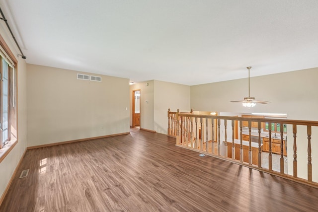 24864 Kettle River Blvd, Wyoming, MN 55025 - empty room featuring wood finished floors, healthy amount of natural light, and a ceiling fan
