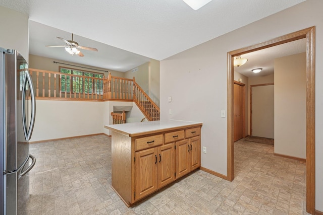 24864 Kettle River Blvd, Wyoming, MN 55025 - kitchen featuring freestanding refrigerator, a ceiling fan, a peninsula, light countertops, and brick patterned flooring