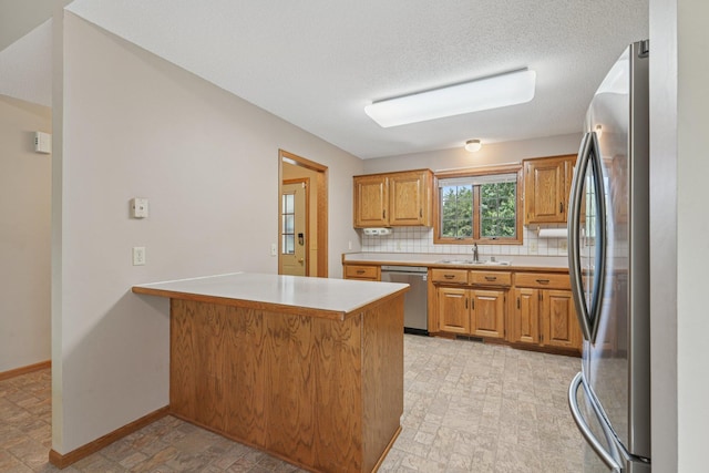 24864 Kettle River Blvd, Wyoming, MN 55025 - kitchen featuring a peninsula, appliances with stainless steel finishes, light countertops, decorative backsplash, and brown cabinets