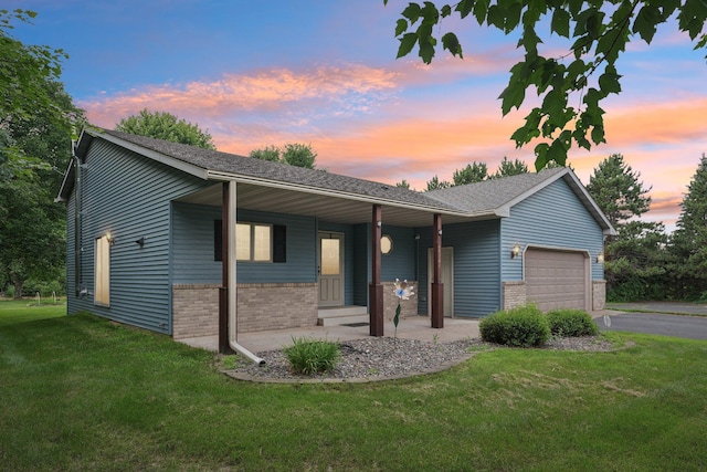24864 Kettle River Blvd, Wyoming, MN 55025 - single story home featuring brick siding, a garage, a yard, covered porch, and driveway