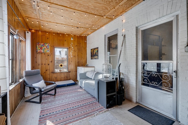 400 8th Ave NE Unit 1, Minneapolis, MN 55413 - sitting room with wooden walls, light wood-style floors, and brick wall