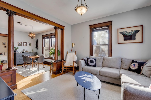 400 8th Ave NE Unit 1, Minneapolis, MN 55413 - living area featuring light wood finished floors, a chandelier, and decorative columns