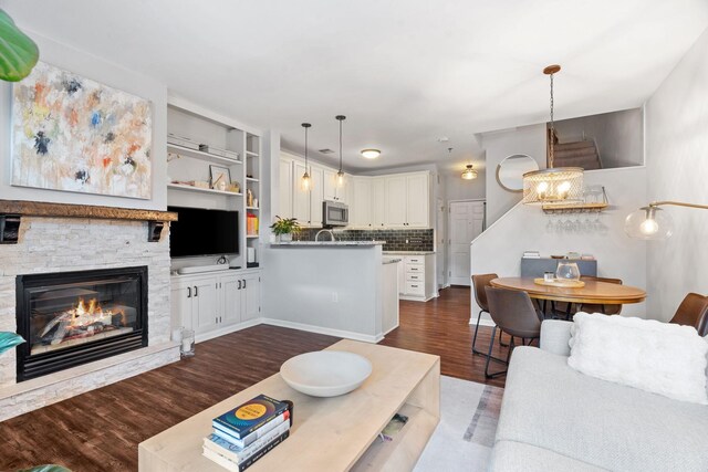 660 2nd St Unit 104, Minneapolis, MN 55401 - living room featuring dark wood finished floors and a stone fireplace