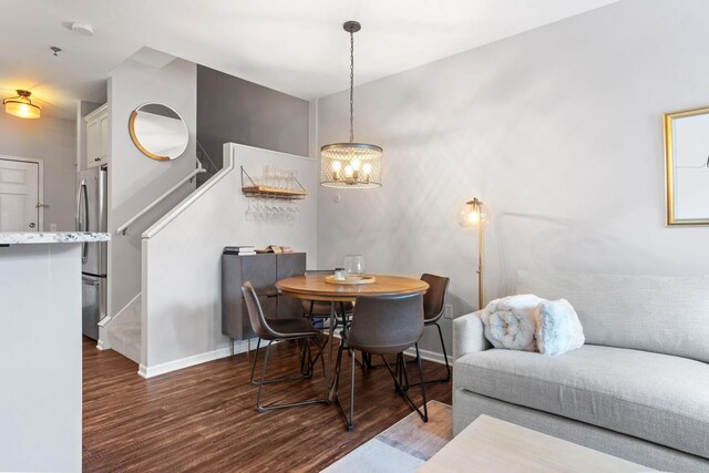 660 2nd St Unit 104, Minneapolis, MN 55401 - dining area with stairs, wood finished floors, and a chandelier