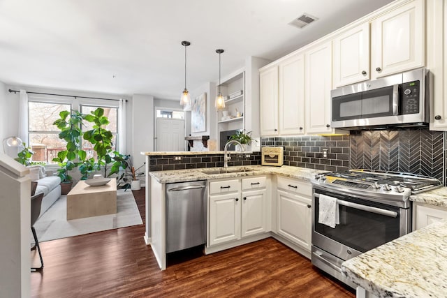 660 2nd St Unit 104, Minneapolis, MN 55401 - kitchen featuring stainless steel appliances, a peninsula, dark wood-type flooring, and white cabinetry