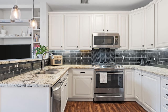 660 2nd St Unit 104, Minneapolis, MN 55401 - kitchen with appliances with stainless steel finishes, dark wood finished floors, and white cabinets