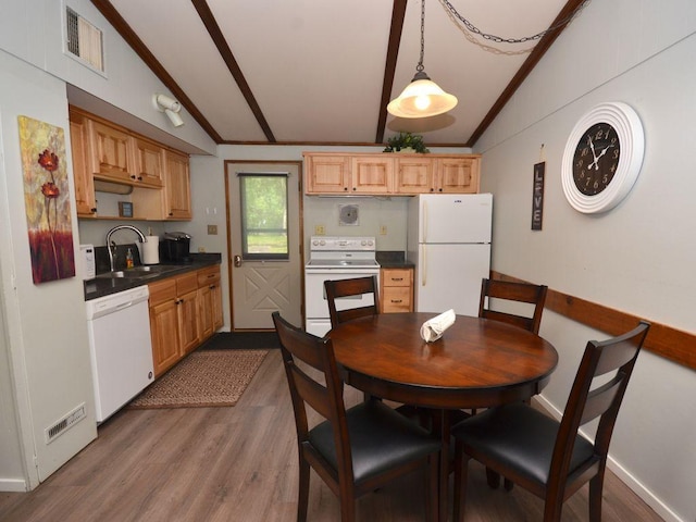 26315 Icon Dr Unit 103, Park Rapids, MN 56470 - dining area with vaulted ceiling, dark wood-style floors, and ornamental molding