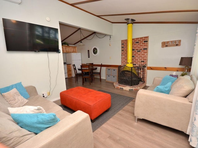 26315 Icon Dr Unit 103, Park Rapids, MN 56470 - living area with a wood stove, wood finished floors, and vaulted ceiling