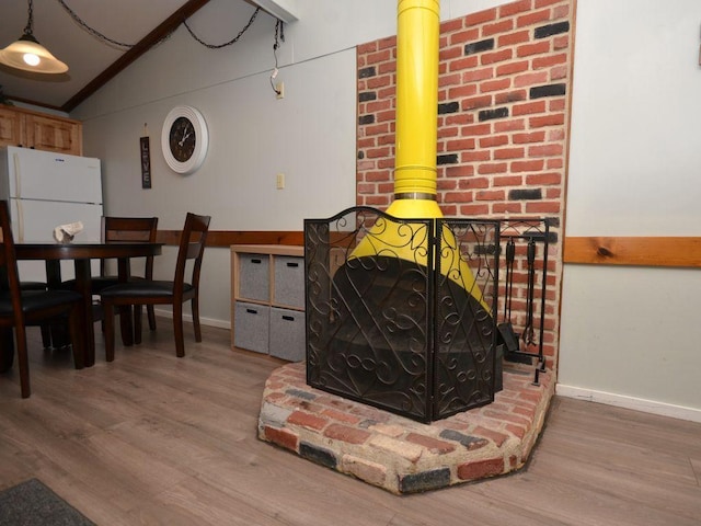 26315 Icon Dr Unit 103, Park Rapids, MN 56470 - living room featuring a wood stove, wood finished floors, and lofted ceiling