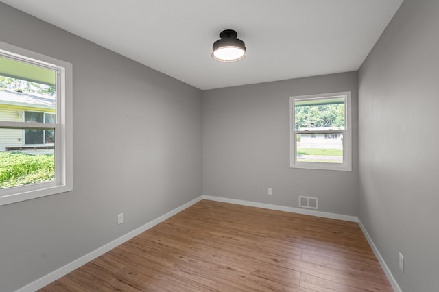 11632 Utah Ave N, Champlin, MN 55316 - spare room featuring light wood-type flooring and baseboards