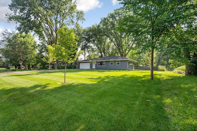 11632 Utah Ave N, Champlin, MN 55316 - view of grassy yard with an attached garage