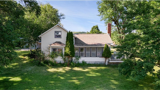 525 Green Coulee Rd, Onalaska, WI 54650 - view of front facade featuring a front lawn, a chimney, roof with shingles, and a wooden deck
