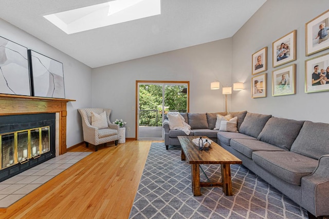 14349 Natchez Ave, Savage, MN 55378 - living area with wood finished floors, a fireplace with flush hearth, a skylight, and lofted ceiling