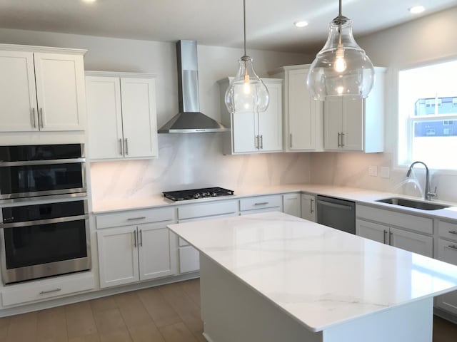 20071 67th Pl, Corcoran, MN 55340 - kitchen with wall chimney range hood, appliances with stainless steel finishes, a center island, white cabinets, and recessed lighting