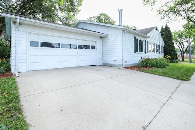 921 16th St S, Fargo, ND 58103 - view of property exterior with driveway, a garage, and crawl space
