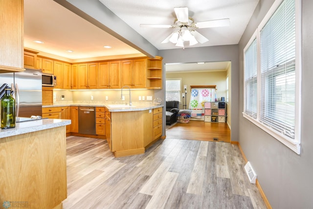 921 16th St S, Fargo, ND 58103 - kitchen with appliances with stainless steel finishes, light wood-style floors, open shelves, ceiling fan, and light stone countertops