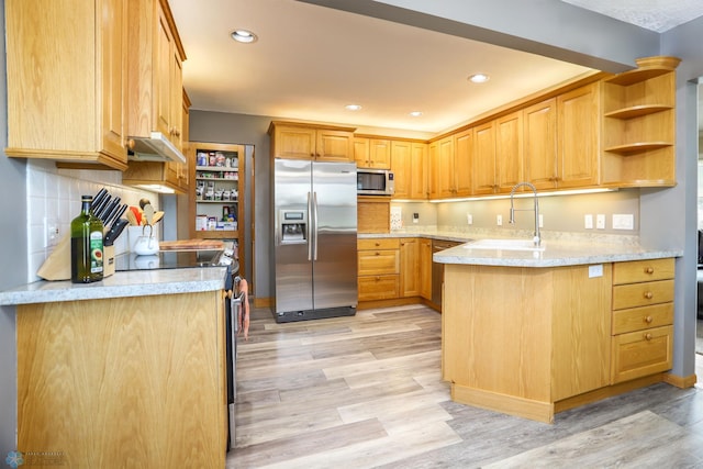 921 16th St S, Fargo, ND 58103 - kitchen with stainless steel appliances, light wood-type flooring, recessed lighting, backsplash, and light stone counters