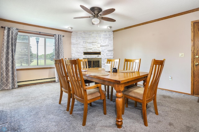 921 16th St S, Fargo, ND 58103 - dining room featuring crown molding, ceiling fan, carpet floors, baseboard heating, and a fireplace