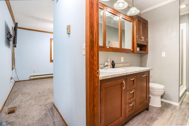921 16th St S, Fargo, ND 58103 - bathroom featuring ornamental molding, vanity, a baseboard heating unit, and a shower with shower door