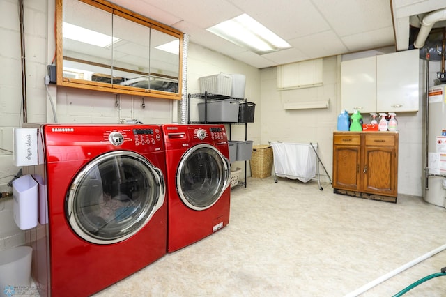 921 16th St S, Fargo, ND 58103 - laundry room with washing machine and dryer, cabinet space, concrete block wall, and tile patterned floors