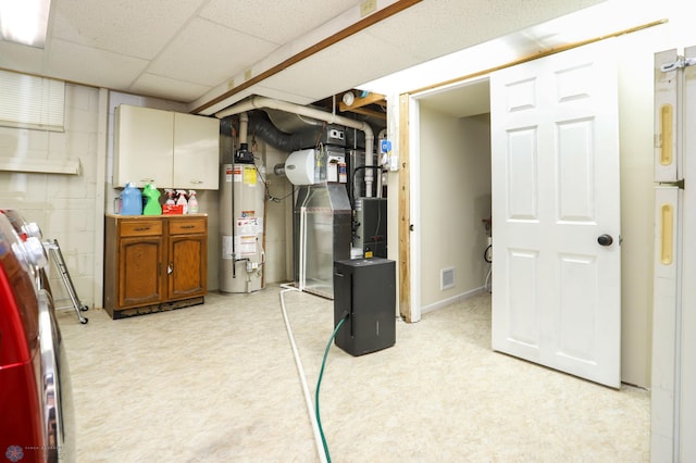 921 16th St S, Fargo, ND 58103 - finished below grade area with water heater, freestanding refrigerator, a drop ceiling, and washer / clothes dryer