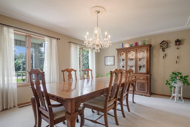 251 Revere Ln N, Champlin, MN 55316 - dining area featuring a chandelier, light colored carpet, and ornamental molding