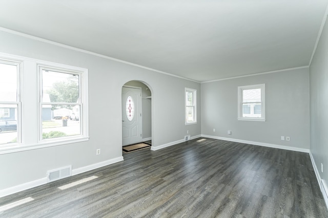 213 11th St SE, Rochester, MN 55904 - unfurnished living room with arched walkways, dark wood-type flooring, and crown molding