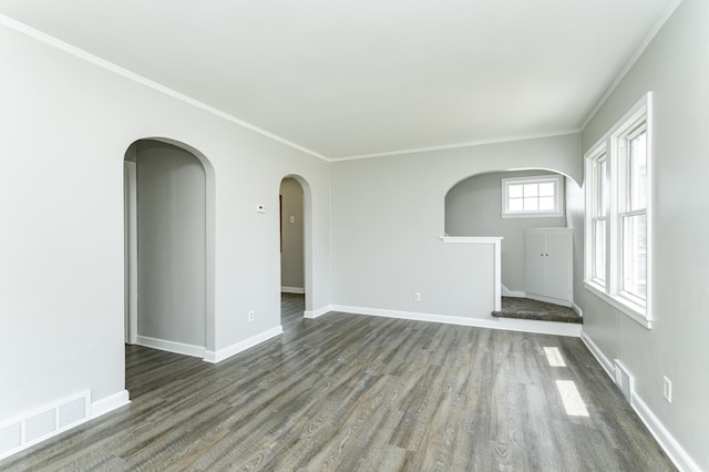 213 11th St SE, Rochester, MN 55904 - unfurnished living room with arched walkways, dark wood-style flooring, and crown molding